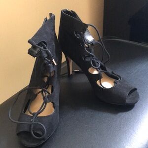 A pair of shoes, Black Suede tie ups with gold tips on shoe strings.